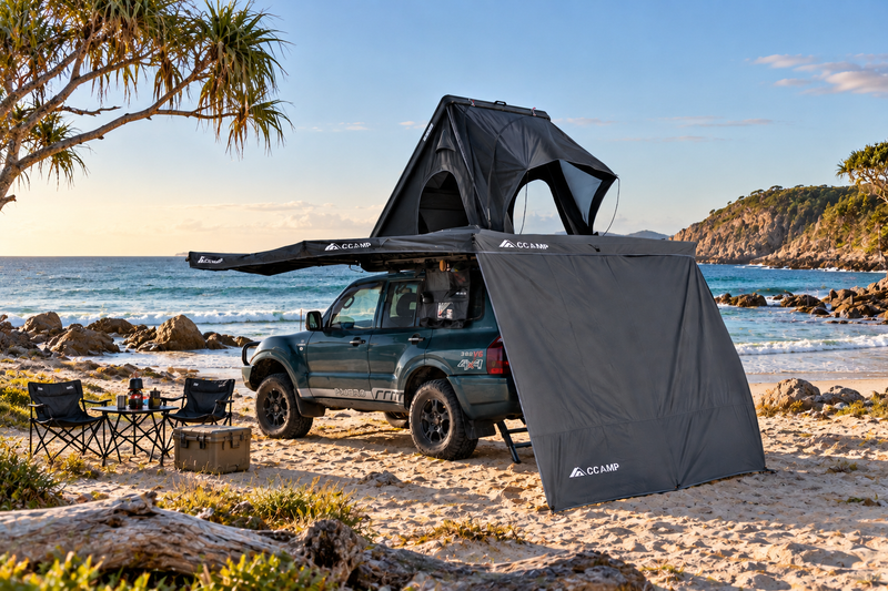 Load image into Gallery viewer, CCAMP rooftop tent and awning wall on a 4WD parked at a beach

