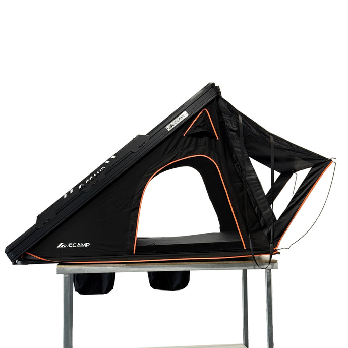 Black and orange tent on display in a showroom setting