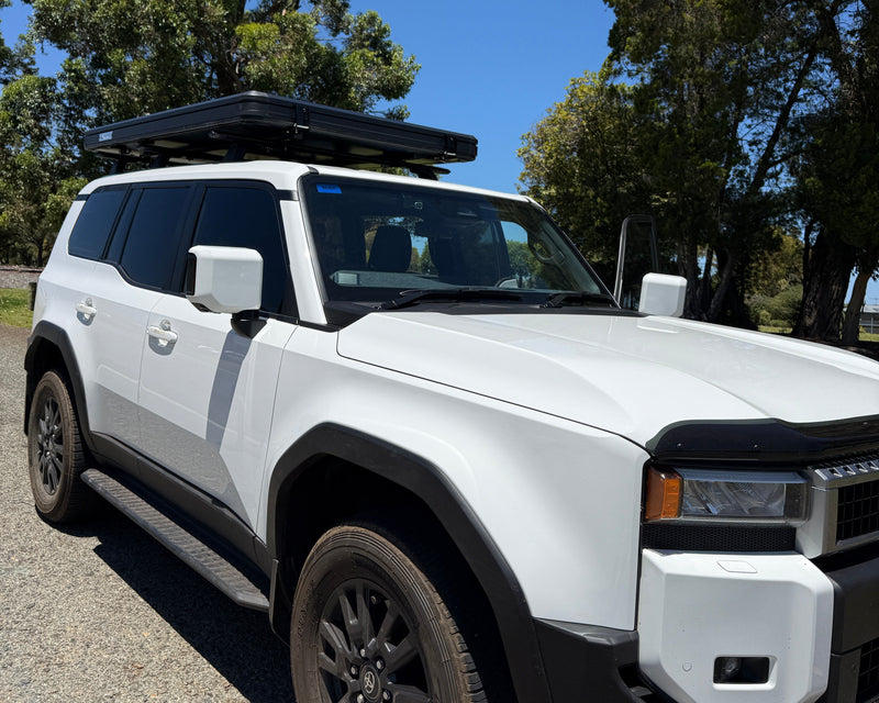 Load image into Gallery viewer, White off-road vehicle on a driveway with trees and blue sky in the background
