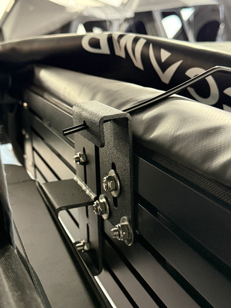 Load image into Gallery viewer, Close-up of a black metal bracket attached to a vehicle's side panel.
