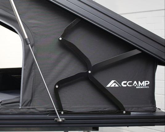 CCamp rooftop tent attached to a vehicle with a white interior.