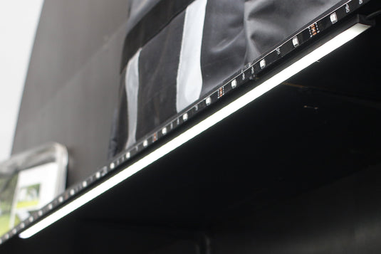 Close-up of a black shelf with a reflective surface, possibly in an indoor setting.