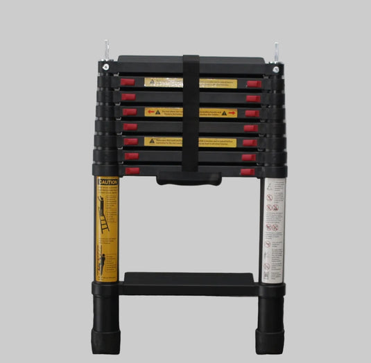 Collapsible work table with multiple drawers against a white brick wall.