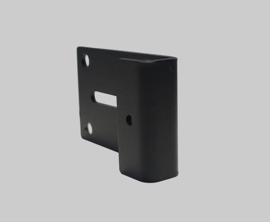 Black metal bracket on a white surface with a gray background