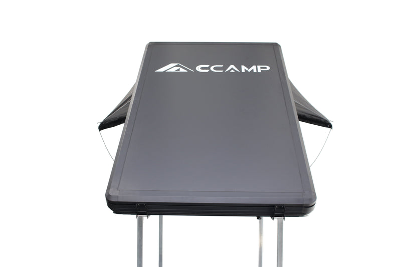 Load image into Gallery viewer, Black folding table with &#39;CCAMP&#39; branding on a white background
